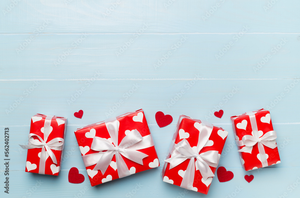 Gift boxes with hearts on wooden background, top view Gift boxes with hearts on wooden background, top view
