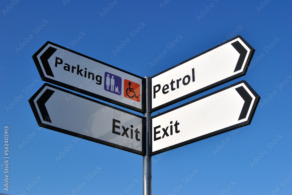 Fototapeta premium Close Up of Sign Post seen against Blue Sky