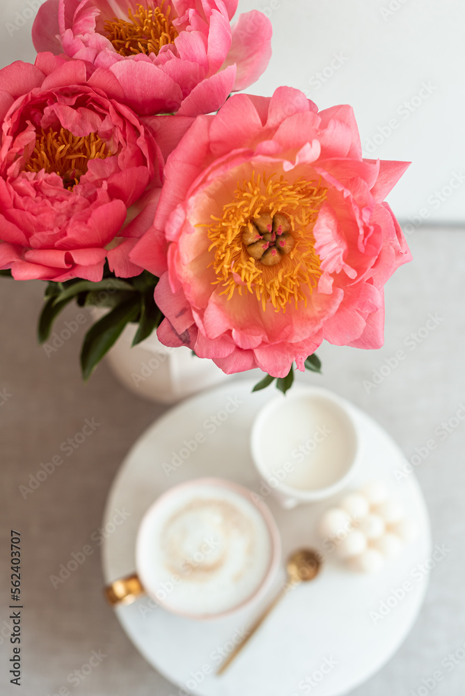 Cup with cappuccino, flowers peony, morning concept, soy candle, woman's day Cup with cappuccino, flowers peony, morning concept, soy candle, woman's day