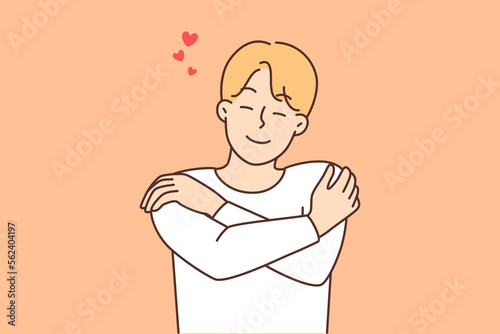 Smiling man hug himself show self-love