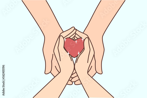 Couple hold heart in hands 