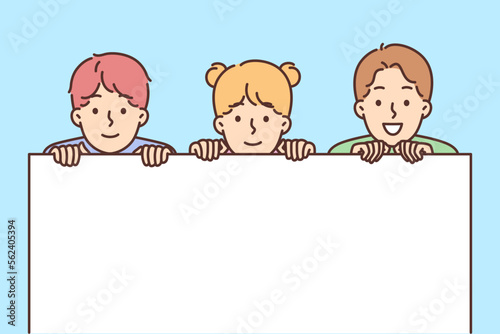 Smiling children holding mockup banner