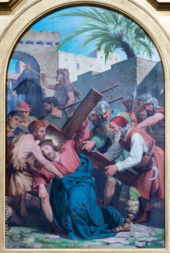 VARALLO, ITALY - JULY 17, 2022: The painting Simon of Cyrene helps Jesus carry the cross  in the church Collegiata di San Gaudenzio by Enrico Reffo from end of 19. cent. photo