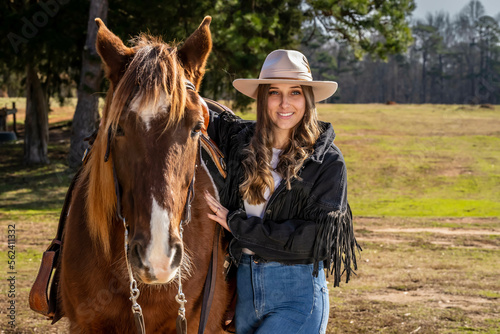 Lovely Brunette Cowgirl Enjoying A Day With Her Horse On Her Farm © Grindstone Media Grp