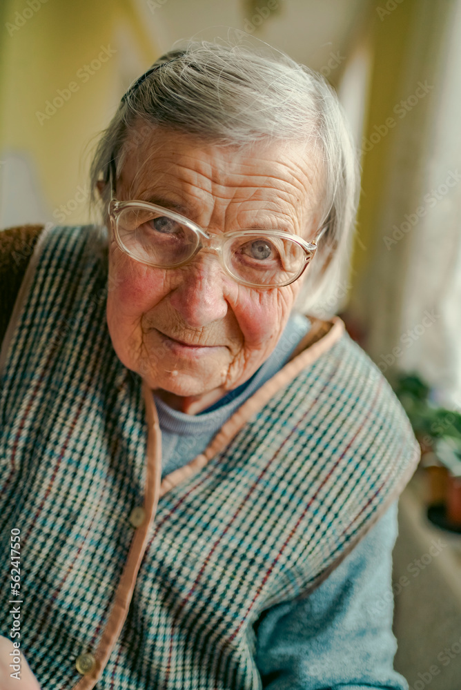 Senior woman in spectacles use sewing machine. wrinkled hands of the old seamstress.elderly woman . Senior woman in spectacles use sewing machine. wrinkled hands of the old seamstress.elderly woman .