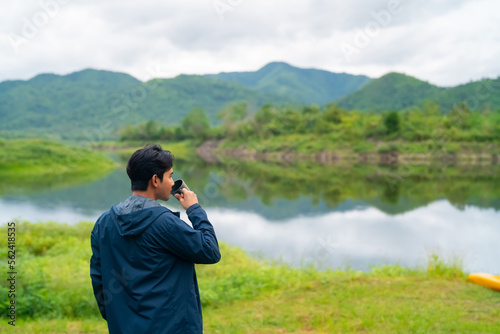 Wallpaper Mural Asian man relax and enjoy outdoor lifestyle hiking and camping in forest mountain while travel on summer holiday vacation trip. Handsome guy brewing and drinking hot coffee by the lake in morning. Torontodigital.ca