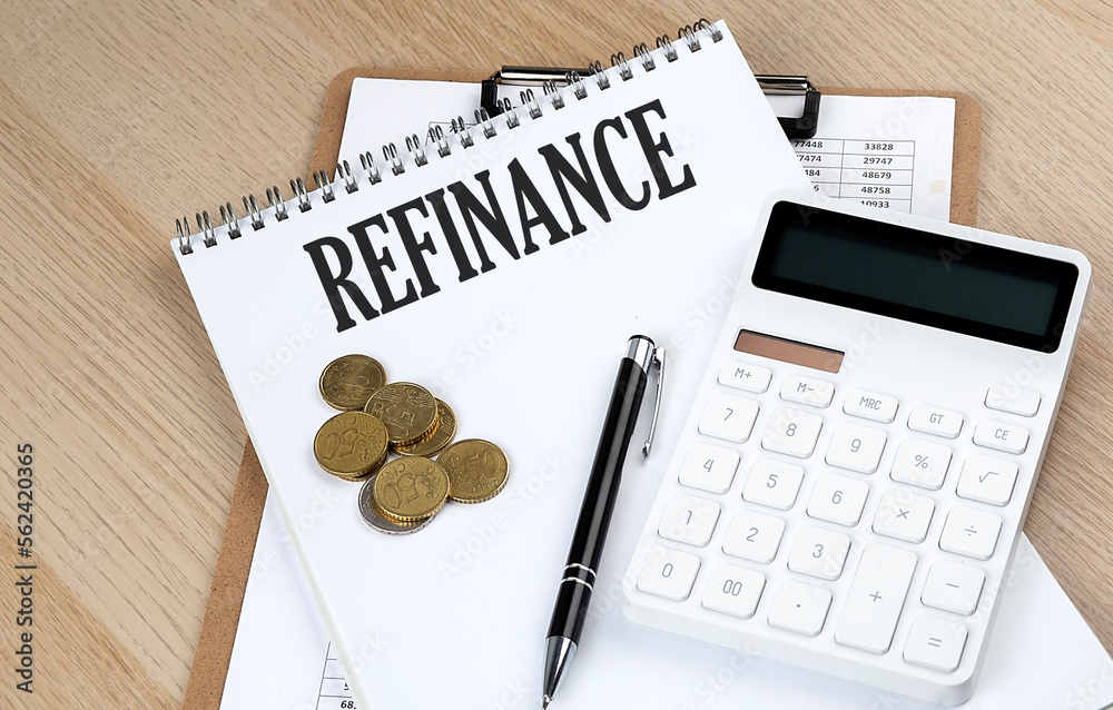 REFINANCE text with chart and calculator and coins , business concept REFINANCE text with chart and calculator and coins , business concept