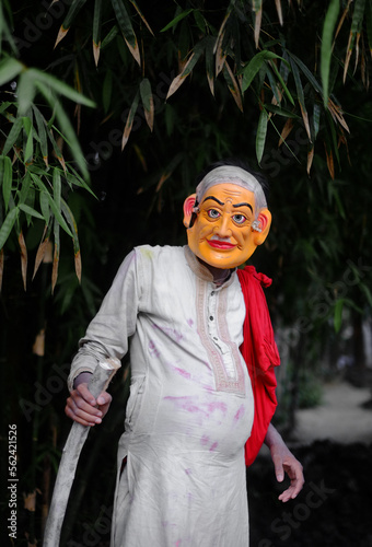 Hindu religious village people celebrating gajan festival wearing colourful costumes  photo