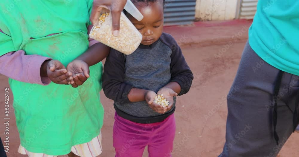Poverty in Africa. Three starving Black African children holding their
