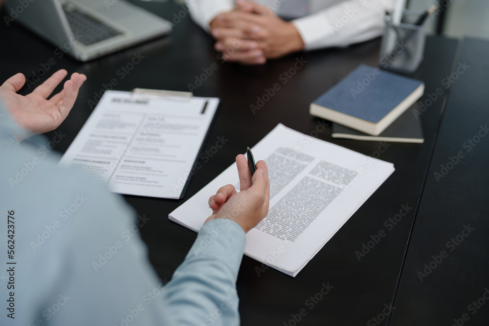Successful job interview, Recruiter or manager and job candidate with resume in office Successful job interview, Recruiter or manager and job candidate with resume in office