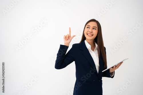 Young beautiful business woman pointing up at copyspace and looking at on pointing over isolated background cheerful with smile on face. Concept of advertising marketing and product placement concept