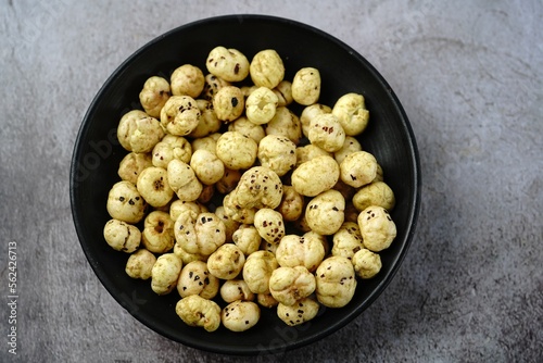 Makhana, also called as Lotus Seeds or Fox Nuts are popular dry snacks from India, served in a bowl. photo
