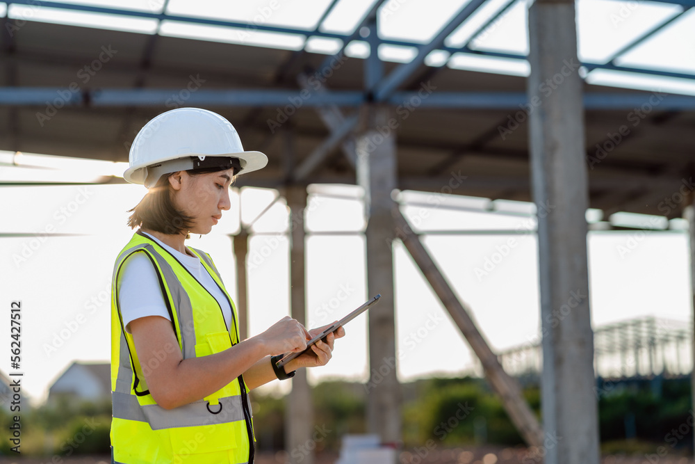Civil Engineer women in safety suite use a digital tablet to work inspection and quality control on construction site .contractor and developer real estate concept Civil Engineer women in safety suite use a digital tablet to work inspection and quality control on construction site .contractor and developer real estate concept
