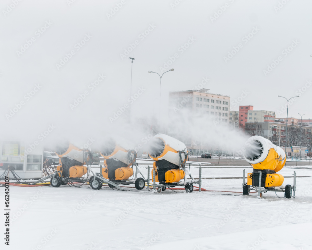 Snow cannons spray artificial snow crystals. Production of artificial snow. Snow guns. Cars make snow.
