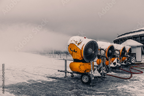 Obraz na płótnie Snow cannons spray artificial snow crystals. Snow guns. Production of artificial snow. Cars make snow. w salonie