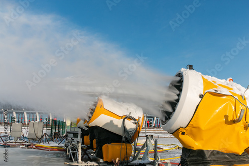 Obraz na płótnie Snow cannons spray artificial snow crystals. Production of artificial snow. Snow guns. Cars make snow. w salonie