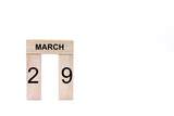 March 29 displayed wooden letter blocks on white background with space for print. Concept for calendar, reminder, date. 