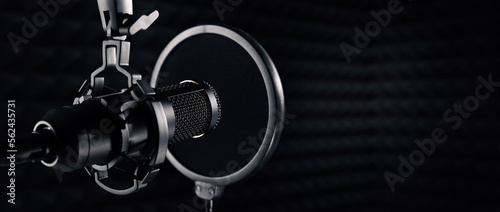 microphone in dark sound recording studio. banner with copy space