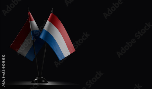 Small national flags of the Netherlands on a black background