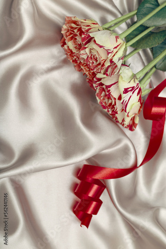 Bouquet of colorful rose flowers on beige satin cloth. Love and romance theme. Valentine day concept. Beautiful floral background