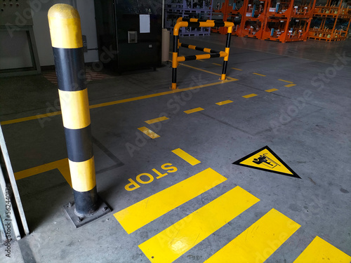 Walkway signs and painted yellow on the factory floor Fototapeta