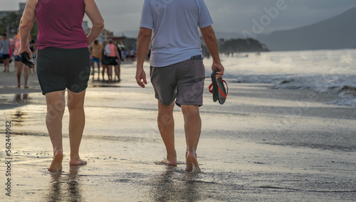 couple, walking and enjoying the sun on the beach