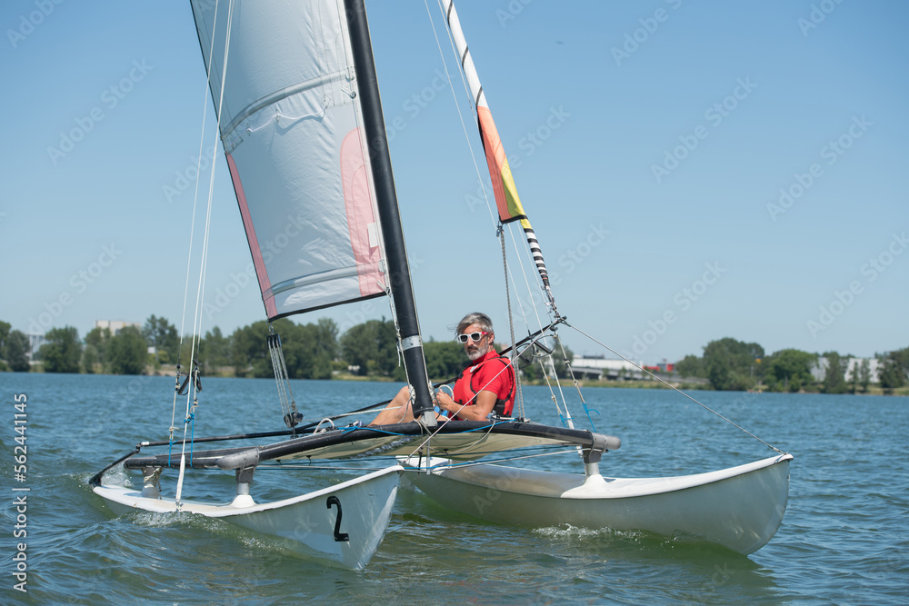 Naklejka premium a sailing man on boat