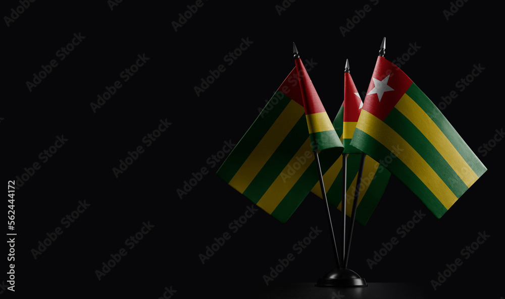 Small national flags of the Togo on a black background