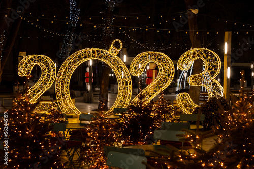 New Year decorations with big yellow numbers 2023. Festive neon illumination, Christmas celebration concept. New year 2023, image for greeting card.