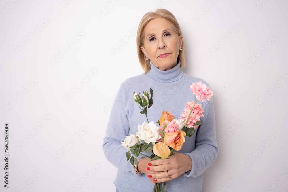 Happy senior woman with bouquet of flowers isolated over white background. Happy senior woman with bouquet of flowers isolated over white background.