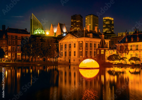 Full Moon behind the Dutch Parliament and skyline at night in The Hague, Netherlands photo