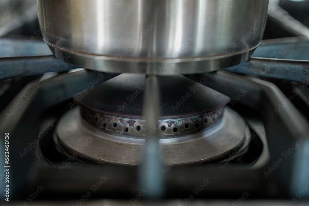 Stainless steel pot on unlit gas stove burner Stainless steel pot on unlit gas stove burner