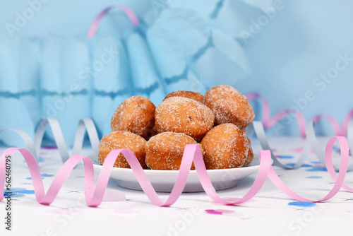 Small German traditional 'Berliner Pfannkuchen', a donut without hole filled with jam. Traditional served during carnival