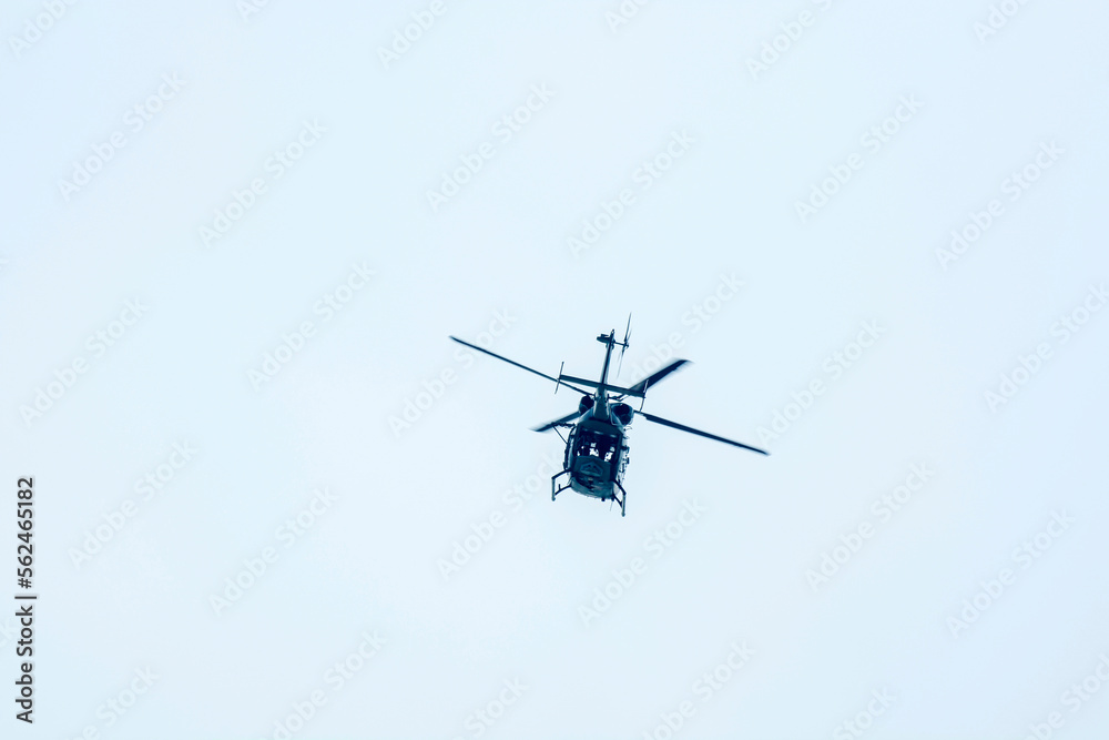 helicopter flew away against blue sky background. helicopter flew away against blue sky background.