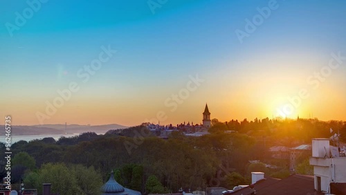 Beautiful Sunrise over Istanbul from top with Bosphorus Bridge and Topkapi Palace Museum timelapse. Istanbul - Turkey. Aerial view from sultanahmet downtown at clear spring morning photo