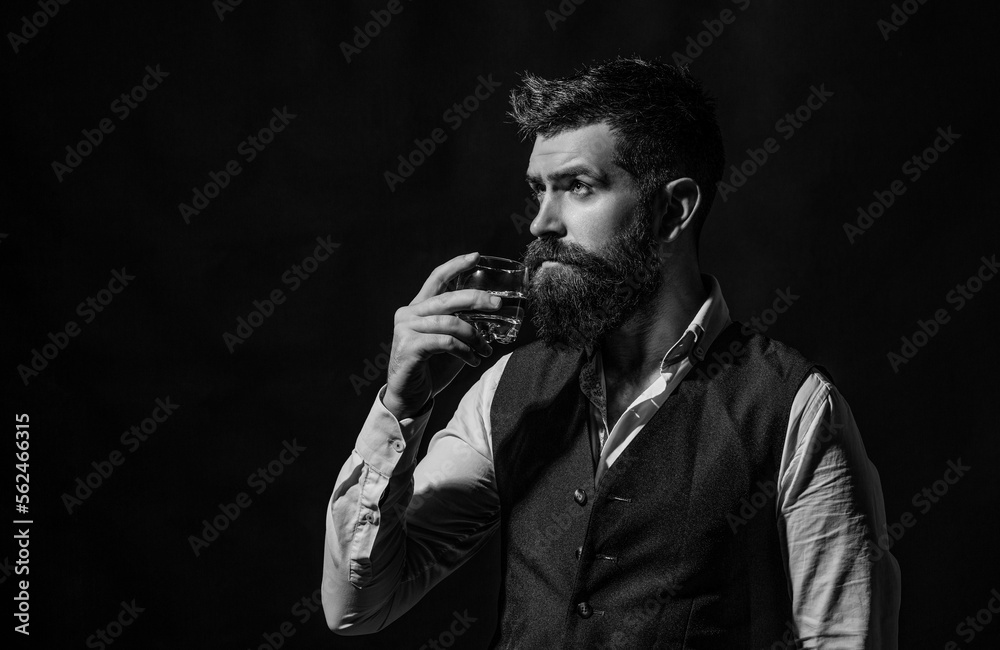Sommelier tastes expensive drink. Degustation, tasting. Bearded businessman in elegant suit with glass of whiskey. Black and white Sommelier tastes expensive drink. Degustation, tasting. Bearded businessman in elegant suit with glass of whiskey. Black and white