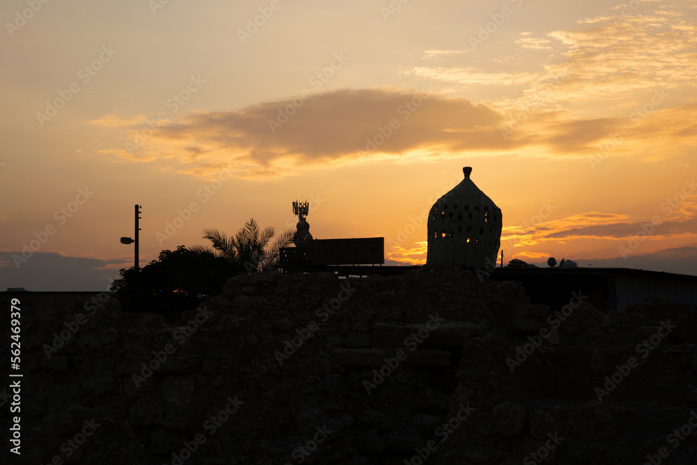 A minaret near Royal burial mound at Aali village during sunset