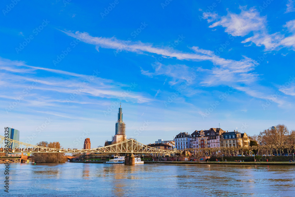 Fototapeta premium View across the Main towards the skyline of Frankfurt am Main on a sunny spring day