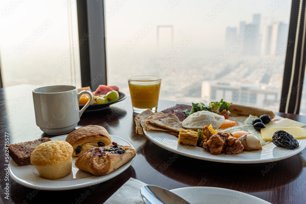 breakfast at hotel with Arabic food on the background of a beautiful view of the sights of Dubai. Beautiful view from the restaurant window. breakfast at hotel with Arabic food on the background of a beautiful view of the sights of Dubai. Beautiful view from the restaurant window.
