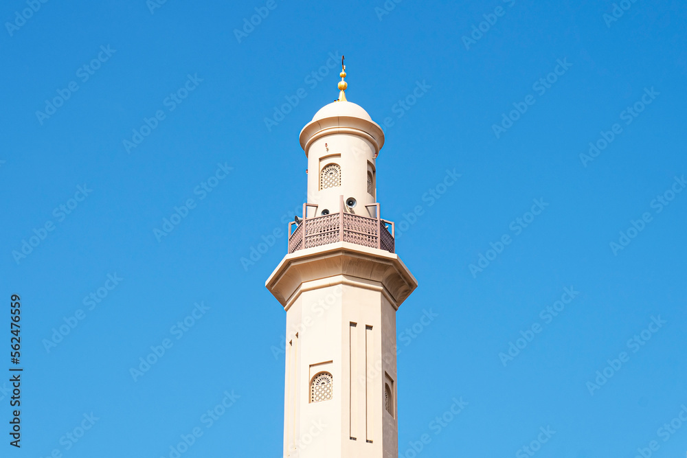 minaret of a mosque from muslim islamic culture, minarets blue sky , historic traditional minaret