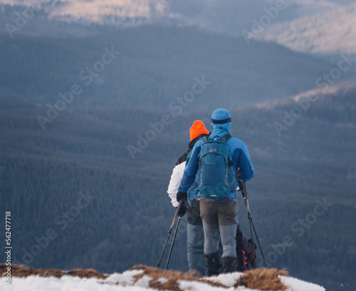 Two trekkers hikers with backpacks walking in the mountains. Carpathian mountain.