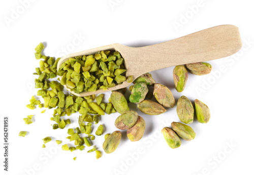 Pistachios chopped and whole peeled pile in wooden spoon isolated on white, top view