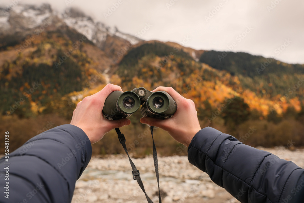 Boy holding binoculars in beautiful mountains, closeup Boy holding binoculars in beautiful mountains, closeup