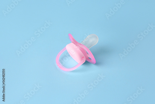 One new baby pacifier on light blue background