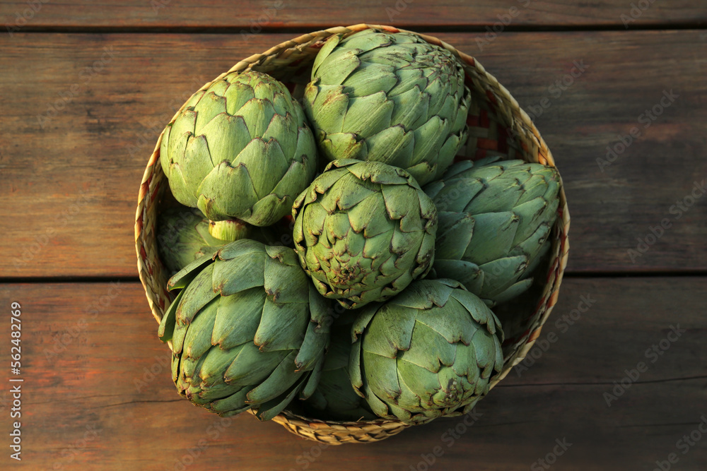 Tasty fresh raw artichokes on wooden table, top view Tasty fresh raw artichokes on wooden table, top view