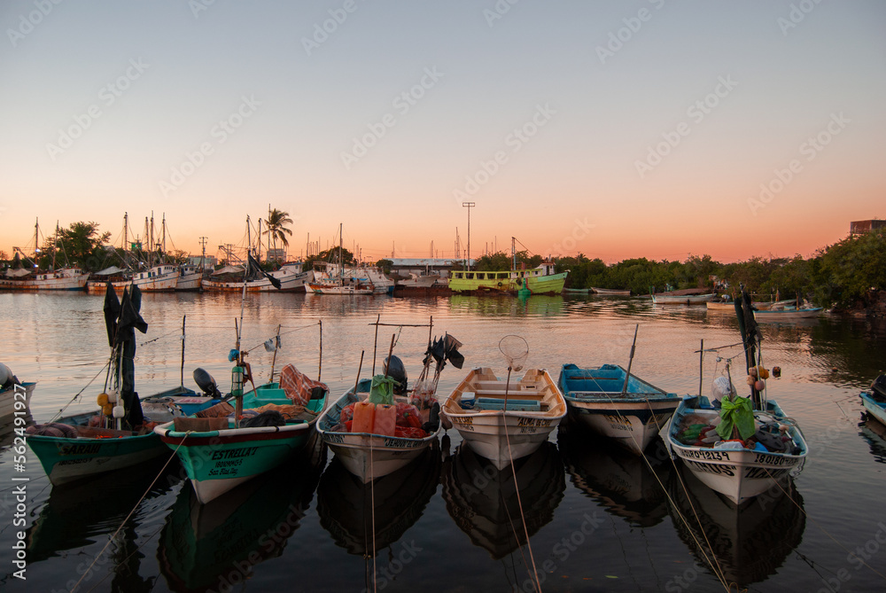 boats in the harbor at sunset