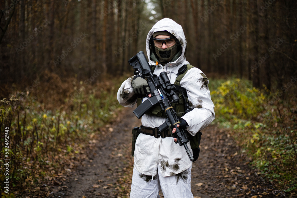 Man in a winter camo suit posing.