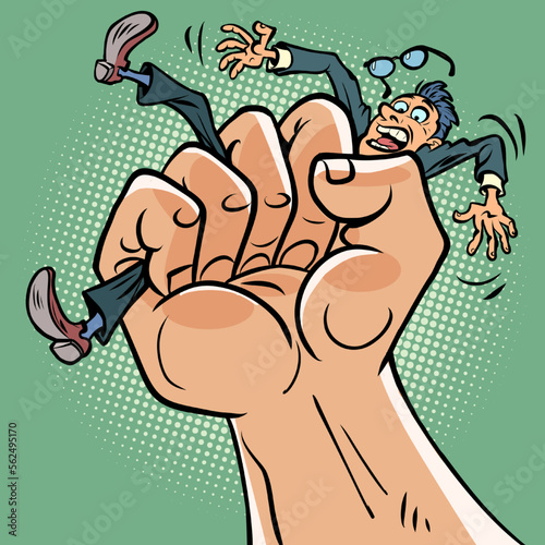 A mans fist squeezes a businessmans man. Pressure stress, politics and dictatorship concept photo