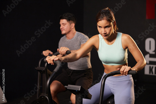 young sporty woman cycling exercise bikes at the gym