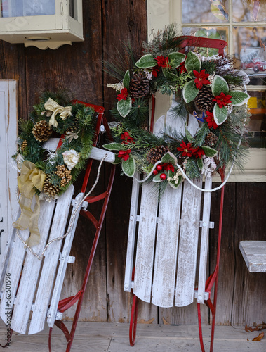 Holiday Christmas Wreaths on old sleds used as holiday decorations photo